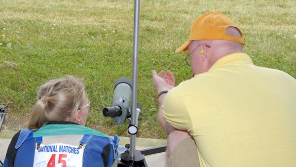 Young Female Competitor Discussing Her Shot with Her Coach 